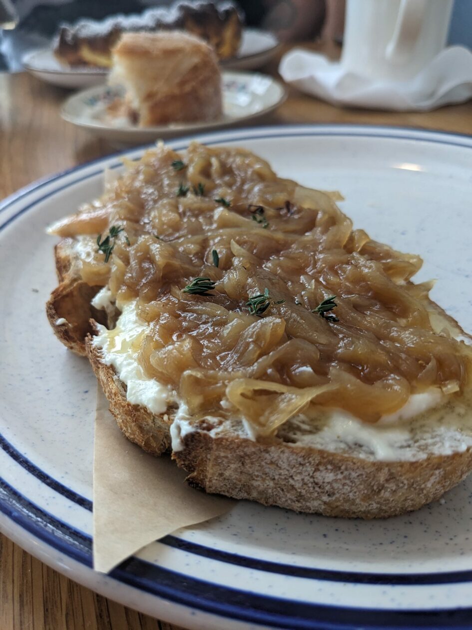 toast covered in cream cheese and caramelized onions